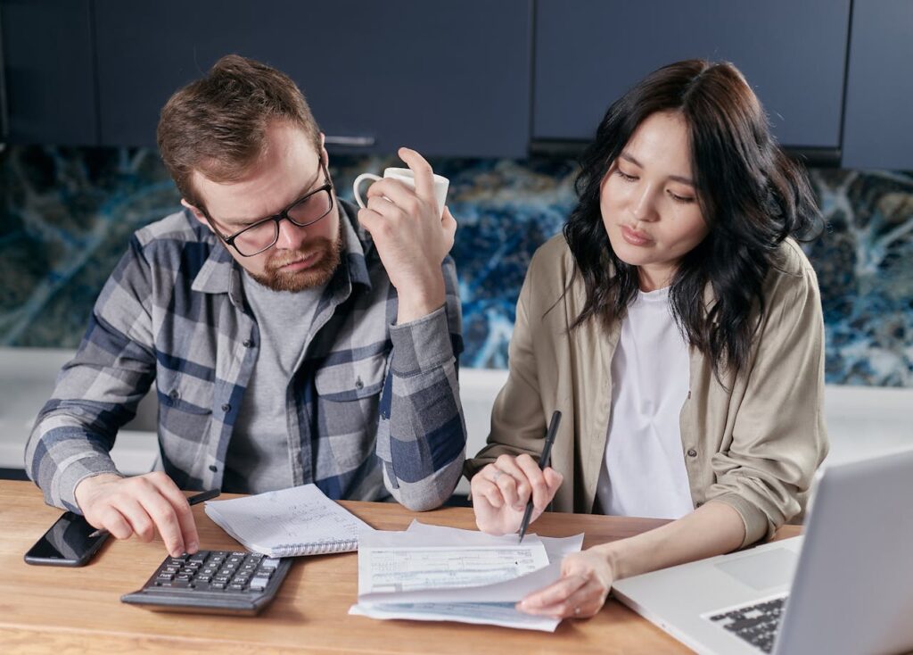A couple reviewing moving estimates and household bills
